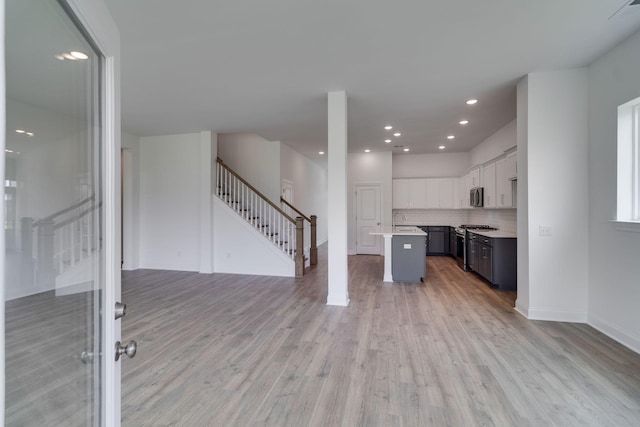 529 Little Penny Dr, Smyrna, TN 37167 - kitchen with open floor plan, light wood-type flooring, stainless steel appliances, light countertops, and recessed lighting