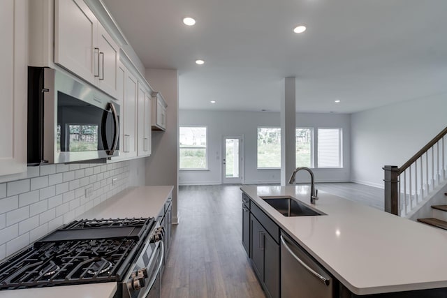 529 Little Penny Dr, Smyrna, TN 37167 - kitchen featuring stainless steel appliances, wood finished floors, a center island with sink, open floor plan, and recessed lighting