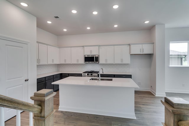 529 Little Penny Dr, Smyrna, TN 37167 - kitchen featuring appliances with stainless steel finishes, tasteful backsplash, light countertops, white cabinets, and recessed lighting