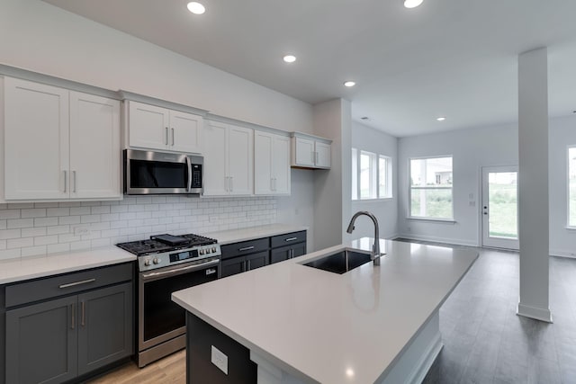 529 Little Penny Dr, Smyrna, TN 37167 - kitchen with stainless steel appliances, backsplash, light countertops, light wood-style flooring, and recessed lighting