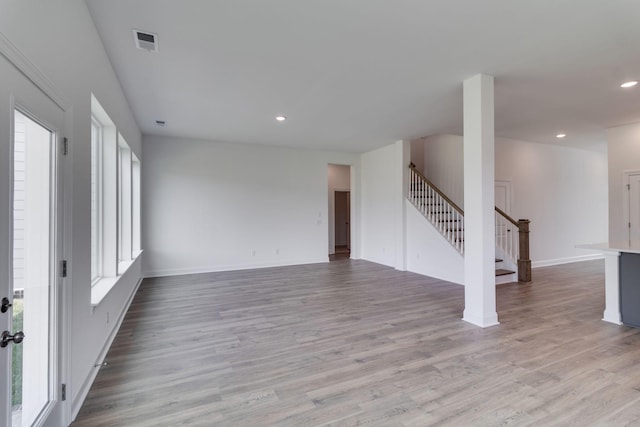 529 Little Penny Dr, Smyrna, TN 37167 - unfurnished living room with plenty of natural light, stairway, wood finished floors, and recessed lighting
