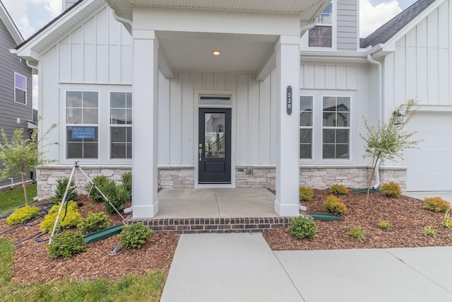 529 Little Penny Dr, Smyrna, TN 37167 - property entrance with board and batten siding, stone siding, covered porch, and a shingled roof