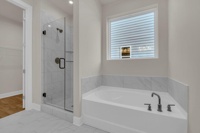 1015 Zane Dr, Mount Juliet, TN 37122 - bathroom featuring a bath, a stall shower, a spacious closet, marble look tiles, and baseboards