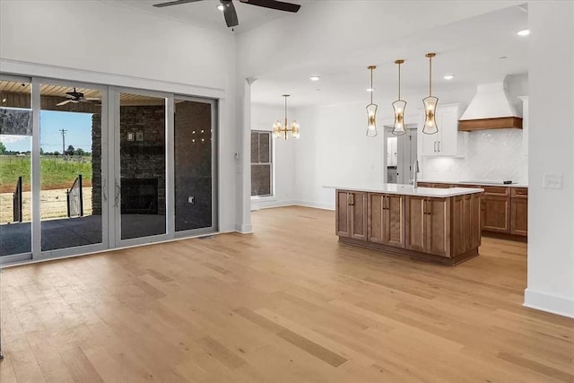 691 Compton Rd, Murfreesboro, TN 37130 - kitchen featuring custom range hood, ceiling fan, light wood-type flooring, light countertops, and recessed lighting