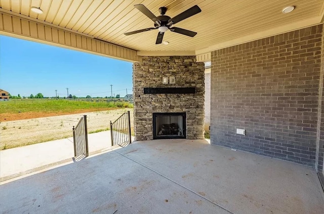 691 Compton Rd, Murfreesboro, TN 37130 - view of patio / terrace featuring an outdoor stone fireplace, a ceiling fan, and a rural view
