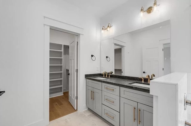 691 Compton Rd, Murfreesboro, TN 37130 - bathroom featuring double vanity, a walk in closet, and wood finished floors