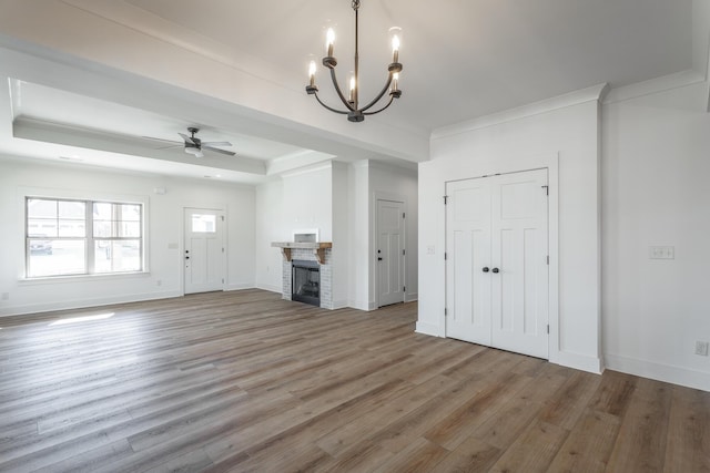 516 Willow Grv Ct, Ringgold, GA 30736 - unfurnished living room with light wood finished floors, ceiling fan, a chandelier, ornamental molding, and a tray ceiling