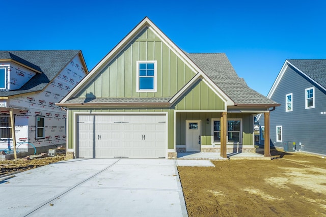 516 Willow Grv Ct, Ringgold, GA 30736 - view of front of house with board and batten siding, covered porch, driveway, a garage, and a shingled roof
