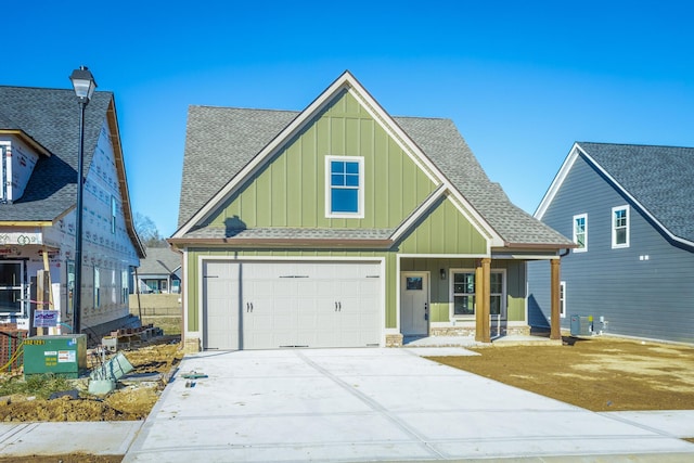 516 Willow Grv Ct, Ringgold, GA 30736 - view of front of house featuring board and batten siding, a shingled roof, concrete driveway, an attached garage, and a porch