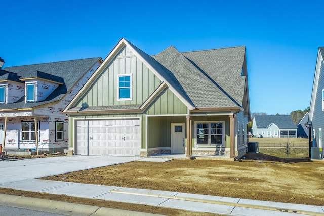 516 Willow Grv Ct, Ringgold, GA 30736 - view of front of property featuring board and batten siding, concrete driveway, central AC unit, roof with shingles, and an attached garage