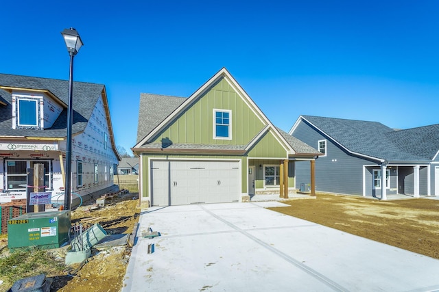 516 Willow Grv Ct, Ringgold, GA 30736 - view of front of house featuring board and batten siding, driveway, a garage, and a shingled roof