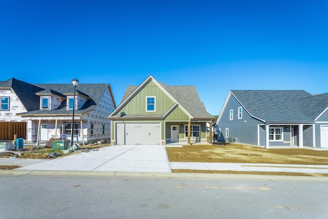 516 Willow Grv Ct, Ringgold, GA 30736 - view of front of home featuring covered porch, board and batten siding, concrete driveway, and a garage