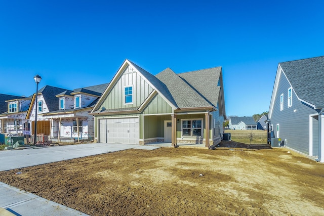 516 Willow Grv Ct, Ringgold, GA 30736 - view of front of property with board and batten siding, a garage, concrete driveway, cooling unit, and roof with shingles