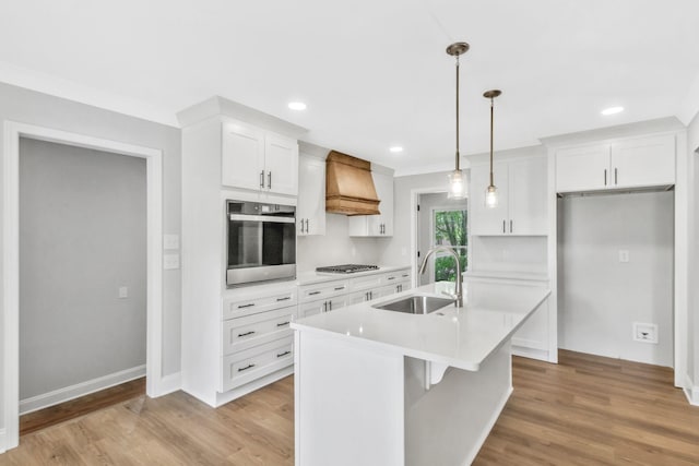 2302 Surrey Dr, Murfreesboro, TN 37129 - kitchen with stainless steel appliances, a sink, premium range hood, light wood-style floors, and white cabinets
