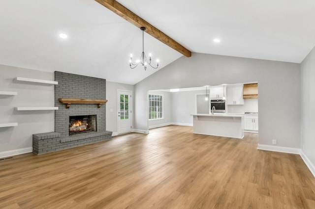 2302 Surrey Dr, Murfreesboro, TN 37129 - unfurnished living room with beam ceiling, a chandelier, baseboards, a fireplace, and light wood-style flooring