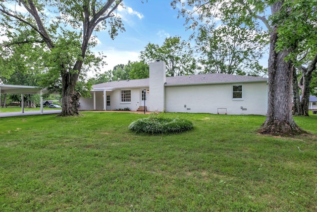 2302 Surrey Dr, Murfreesboro, TN 37129 - back of property featuring a chimney, a yard, and a carport