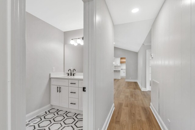2302 Surrey Dr, Murfreesboro, TN 37129 - bathroom featuring vanity, vaulted ceiling, wood finished floors, and baseboards