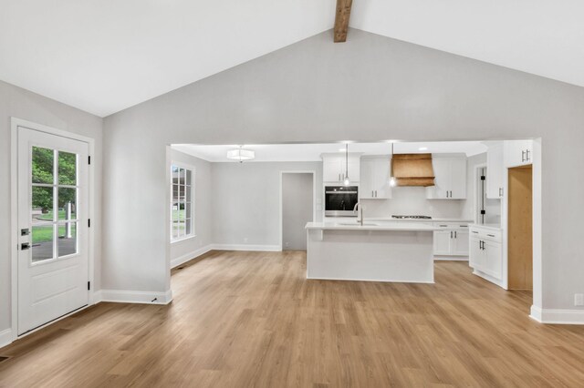 2302 Surrey Dr, Murfreesboro, TN 37129 - kitchen with oven, light countertops, premium range hood, baseboards, and light wood-type flooring