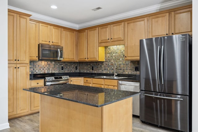 1816 Brentwood Pointe, Franklin, TN 37067 - kitchen with appliances with stainless steel finishes, a sink, light wood finished floors, a kitchen island, and dark stone countertops