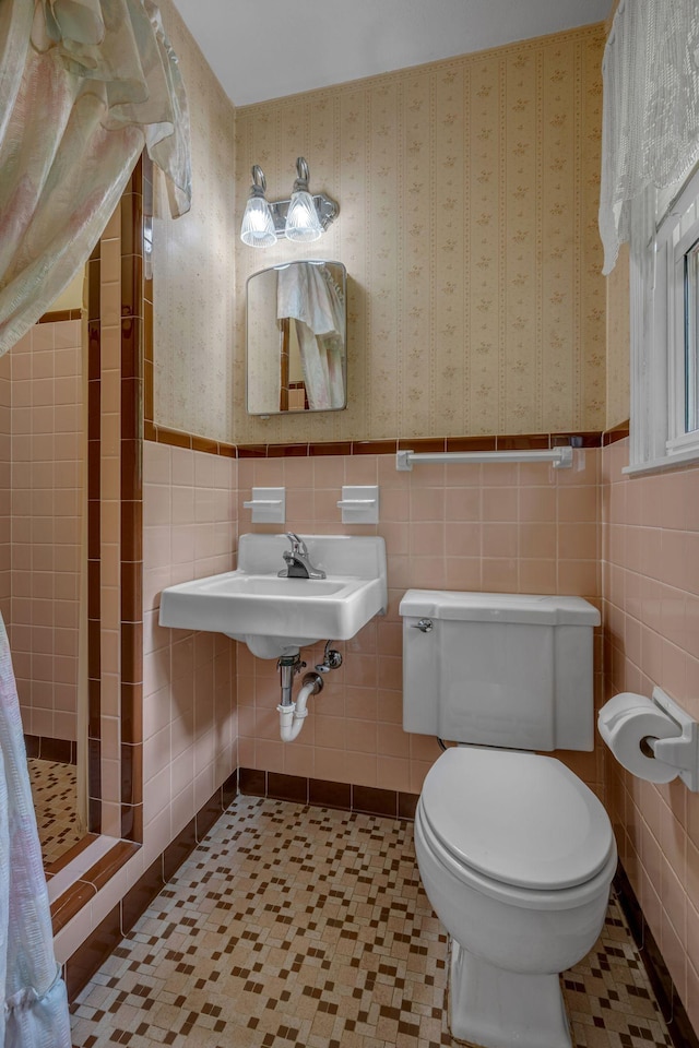 311 Broadview Dr, Dickson, TN 37055 - full bathroom with a shower stall, toilet, tile walls, a wainscoted wall, and a sink