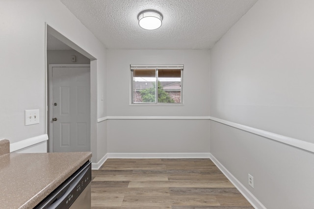 276 White Bridge Pike Unit 70, Nashville, TN 37209 - unfurnished dining area featuring a textured ceiling, light wood finished floors, and baseboards