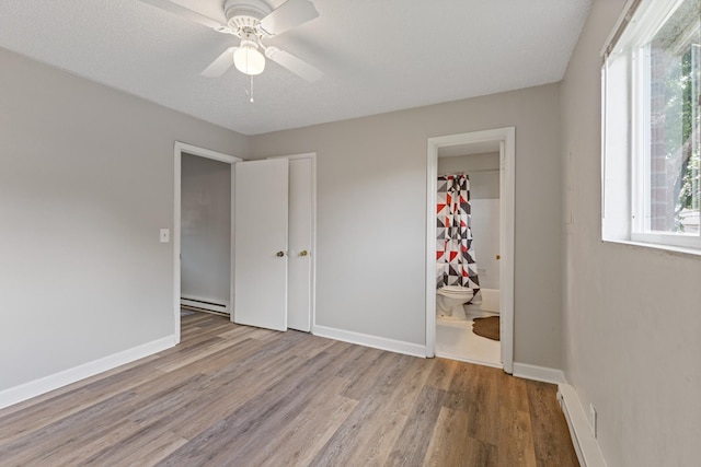 276 White Bridge Pike Unit 70, Nashville, TN 37209 - unfurnished bedroom featuring baseboard heating, wood finished floors, and baseboards