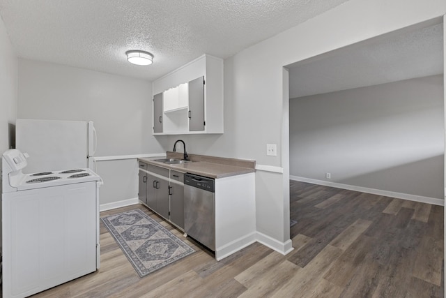 276 White Bridge Pike Unit 70, Nashville, TN 37209 - kitchen featuring white appliances, a sink, light wood-type flooring, a textured ceiling, and baseboards