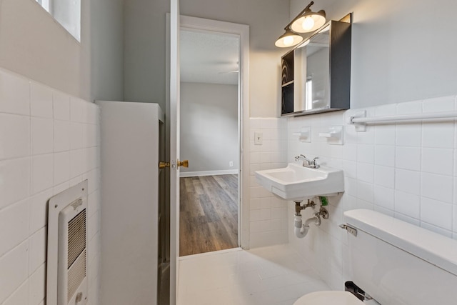 276 White Bridge Pike Unit 70, Nashville, TN 37209 - half bath featuring tile walls, heating unit, toilet, wood finished floors, and wainscoting