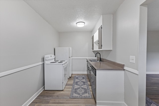 276 White Bridge Pike Unit 70, Nashville, TN 37209 - laundry room featuring a textured ceiling, light wood-type flooring, and baseboards