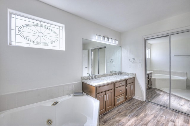3117 Harborwood Dr, Nashville, TN 37214 - bathroom featuring double vanity, a whirlpool tub, and wood finished floors