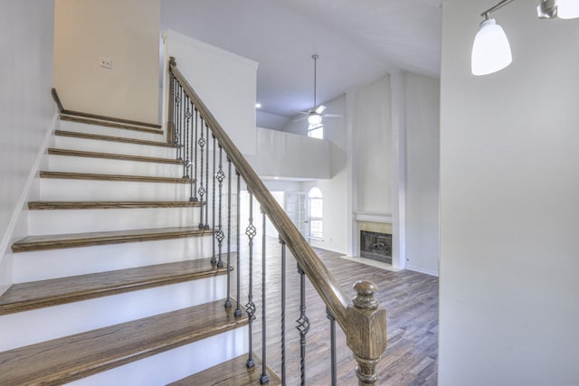 3117 Harborwood Dr, Nashville, TN 37214 - stairway with high vaulted ceiling, a ceiling fan, a fireplace, wood finished floors, and baseboards