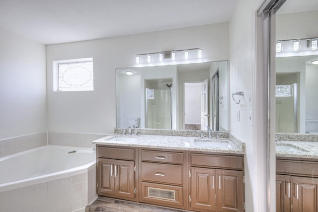 3117 Harborwood Dr, Nashville, TN 37214 - full bathroom with double vanity, a garden tub, a shower, wood finished floors, and toilet