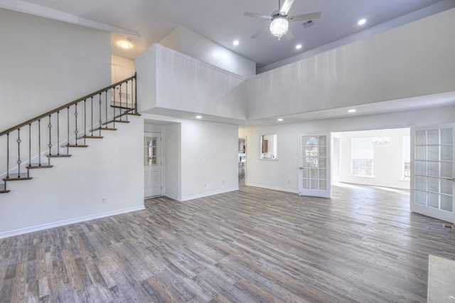 3117 Harborwood Dr, Nashville, TN 37214 - unfurnished living room with a high ceiling, ceiling fan, wood finished floors, a chandelier, and baseboards