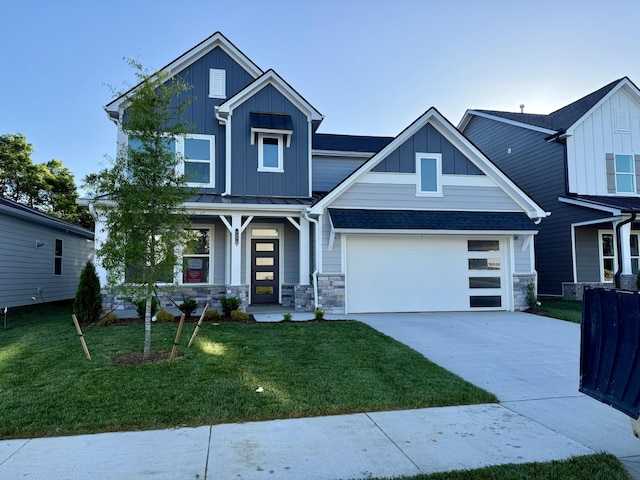 1279 Linn Cove Ct, Gallatin, TN 37066 - craftsman-style house with board and batten siding, concrete driveway, a front lawn, a garage, and stone siding