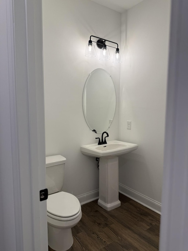 1279 Linn Cove Ct, Gallatin, TN 37066 - half bathroom featuring baseboards, wood finished floors, and toilet