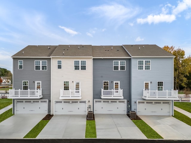 4038 Gaskill Dr Unit 113B, Smyrna, TN 37167 - rear view of property featuring an attached garage, concrete driveway, and cooling unit