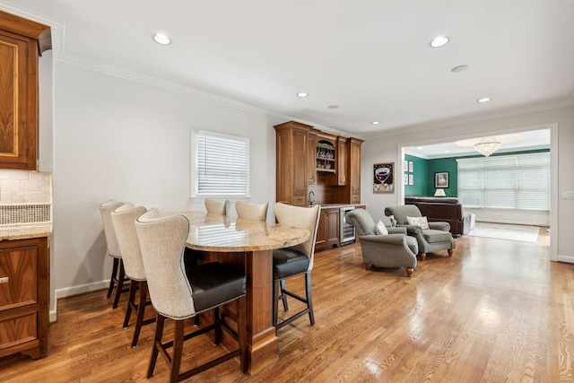 327 Whitworth Way, Nashville, TN 37205 - dining space featuring bar area, ornamental molding, plenty of natural light, recessed lighting, and light wood-style flooring