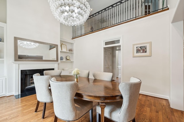 327 Whitworth Way, Nashville, TN 37205 - dining space featuring a chandelier, a high ceiling, wood finished floors, built in shelves, and baseboards