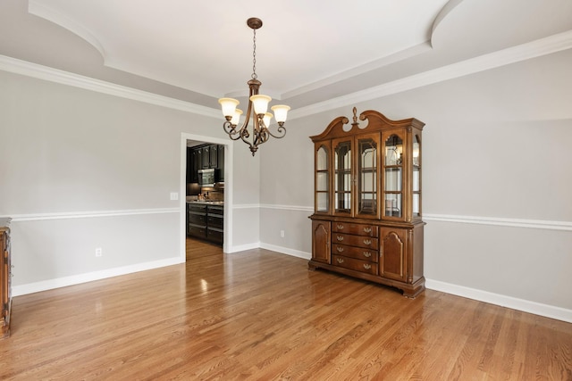 1010 Saint Blaise Trl, Gallatin, TN 37066 - unfurnished room featuring a chandelier, a tray ceiling, wood finished floors, baseboards, and ornamental molding