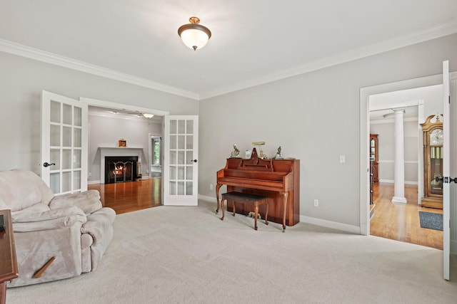 1010 Saint Blaise Trl, Gallatin, TN 37066 - carpeted living room featuring french doors, ornamental molding, a warm lit fireplace, decorative columns, and baseboards