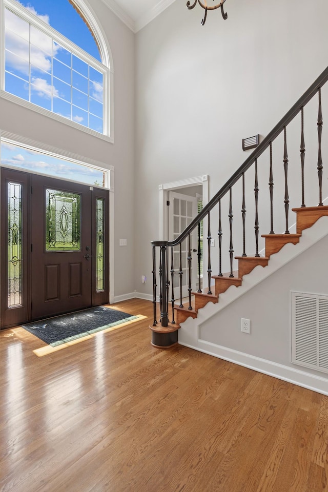 1010 Saint Blaise Trl, Gallatin, TN 37066 - entrance foyer featuring a towering ceiling, ornamental molding, wood finished floors, baseboards, and stairway