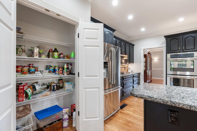 1010 Saint Blaise Trl, Gallatin, TN 37066 - kitchen with stainless steel appliances, light wood-style flooring, light stone counters, ornamental molding, and recessed lighting