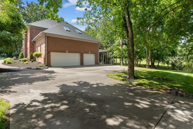1010 Saint Blaise Trl, Gallatin, TN 37066 - view of home's exterior featuring brick siding, concrete driveway, a lawn, and a shingled roof