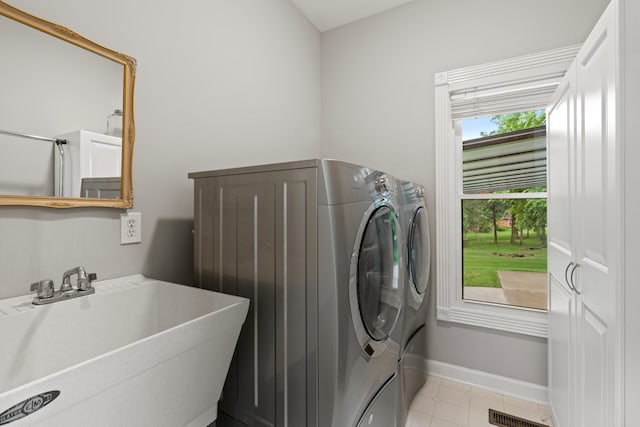 1010 Saint Blaise Trl, Gallatin, TN 37066 - laundry area with washing machine and clothes dryer, baseboards, and light tile patterned flooring