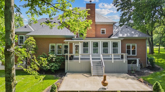 1010 Saint Blaise Trl, Gallatin, TN 37066 - rear view of house with a chimney, a shingled roof, brick siding, a patio, and a yard