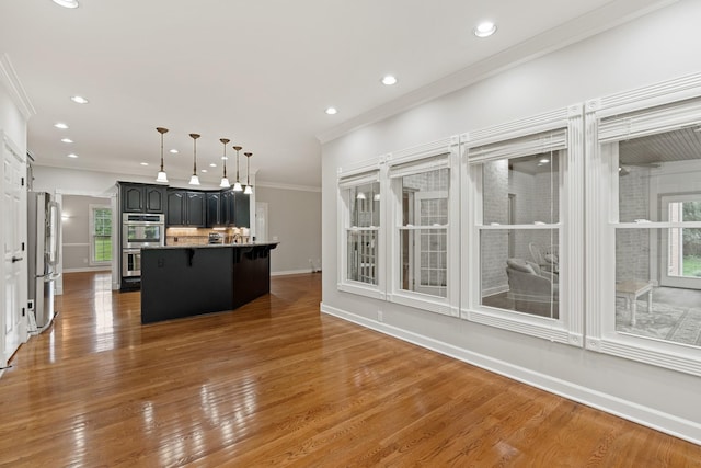 1010 Saint Blaise Trl, Gallatin, TN 37066 - kitchen with stainless steel appliances, a kitchen breakfast bar, recessed lighting, a center island, and wood finished floors