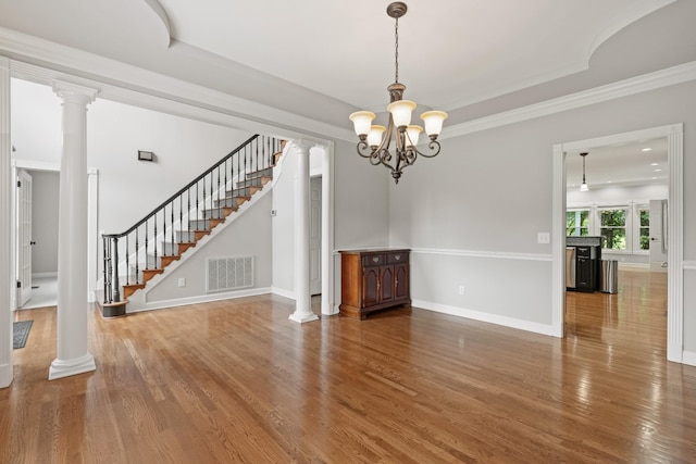 1010 Saint Blaise Trl, Gallatin, TN 37066 - unfurnished living room with wood finished floors, stairs, decorative columns, a chandelier, and ornamental molding