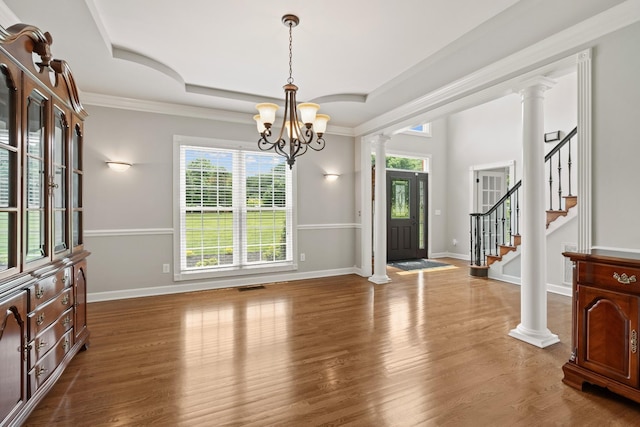 1010 Saint Blaise Trl, Gallatin, TN 37066 - entryway with healthy amount of natural light, a chandelier, ornate columns, wood finished floors, and ornamental molding