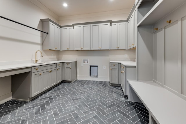 2756 Otterham Dr, Thompsons Station, TN 37179 - laundry area with cabinet space, recessed lighting, baseboards, and brick patterned floors