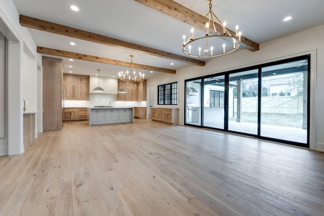 2756 Otterham Dr, Thompsons Station, TN 37179 - unfurnished living room featuring a chandelier, a sink, beamed ceiling, recessed lighting, and light wood finished floors